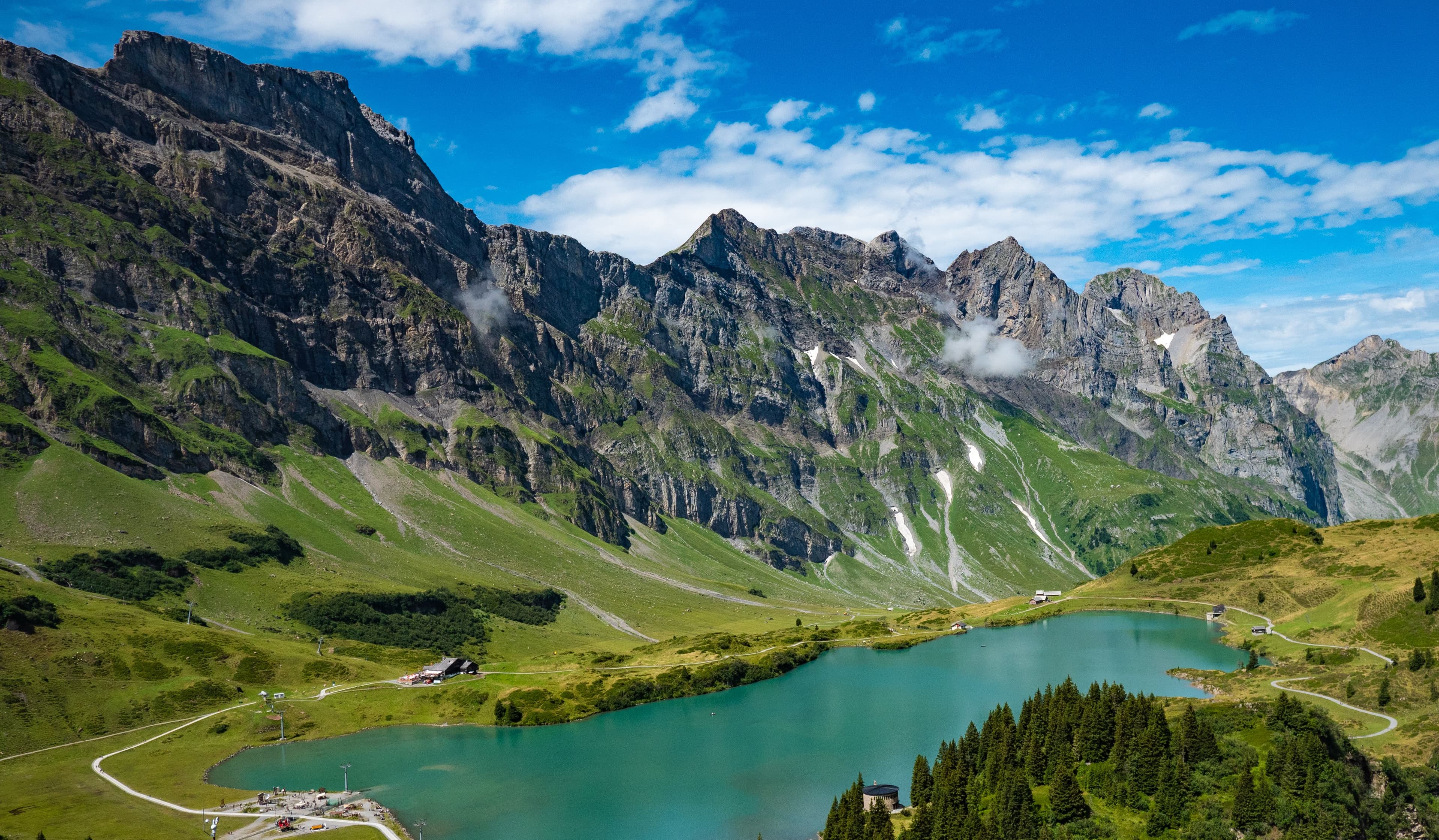 Turquoise alpine lake beneath the Swiss Alps in summer